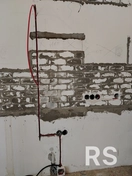 На фото показан перенос розеток на кухне: выполнена штроба под проводку, кабели соединены методом опрeсовки для надёжного контакта.