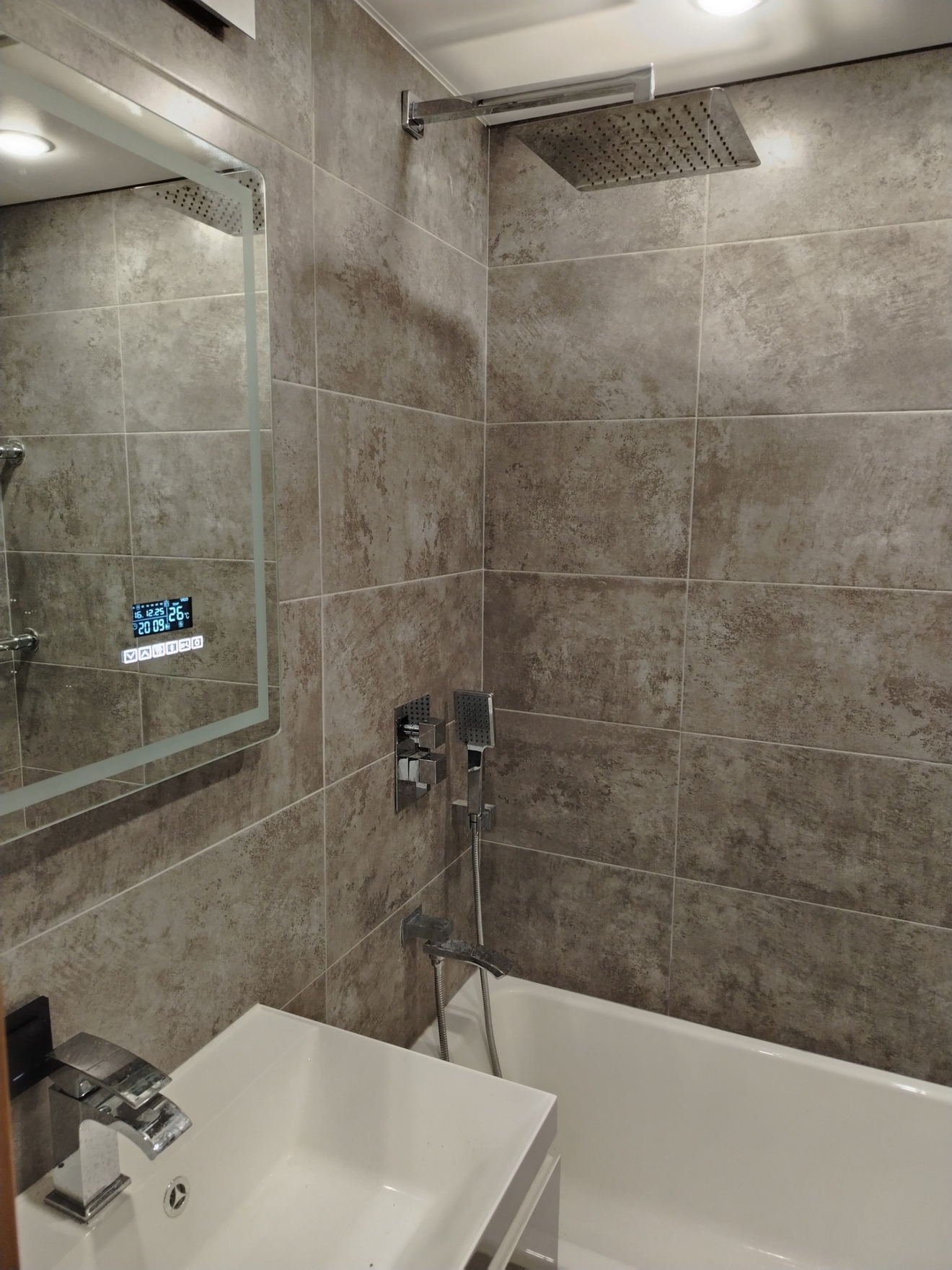 Укладка плитки на стены, монтаж душевой системы скрытого монтажа, тёплый пол, подсветка экрана ванной и потолка.