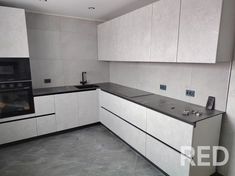 На кухне выполнена укладка плитки. Фартук из глянцевой керамической плитки уложен с минимальными швами и затерт эпоксидной затиркой, обеспечивающей долговечность и влагостойкость.